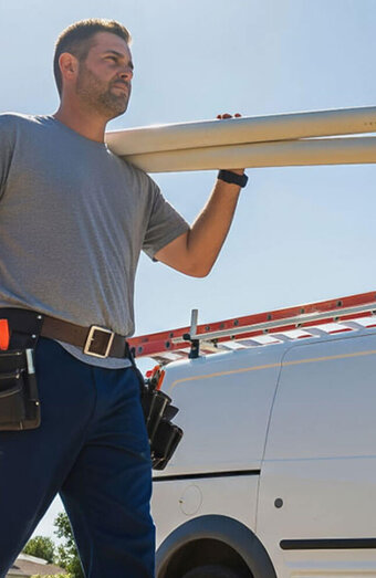 Plumber Carrying Pipes